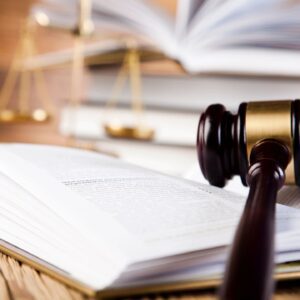 A judge 's gavel on top of an open book.