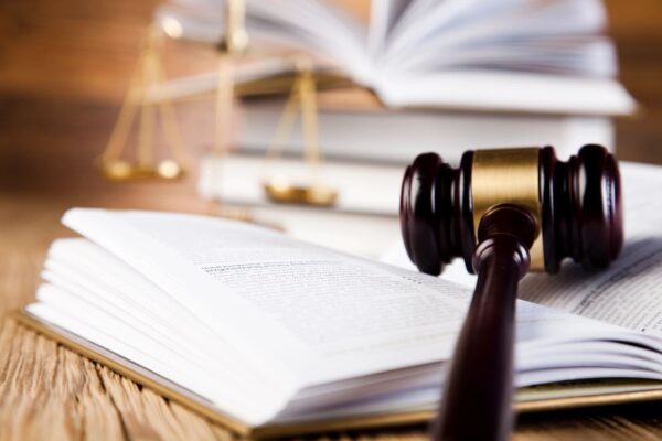 A judge 's gavel on top of an open book.